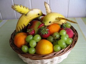 Vaisių ir uogų krepšelis su bananiniais paukščiais
